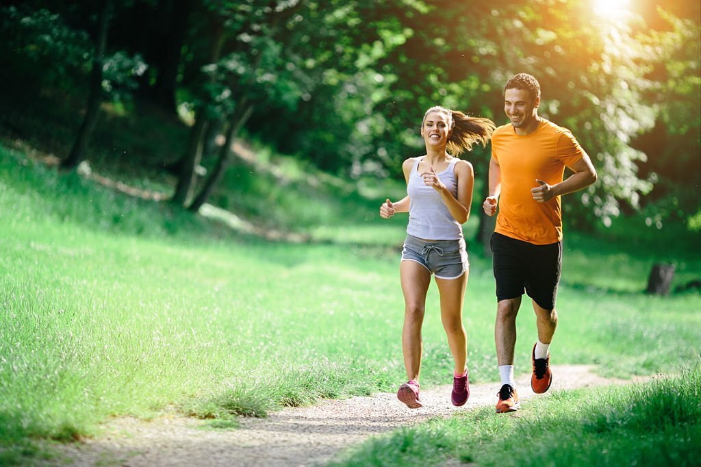 Healthy couple Activities jogging in nature in good spirit